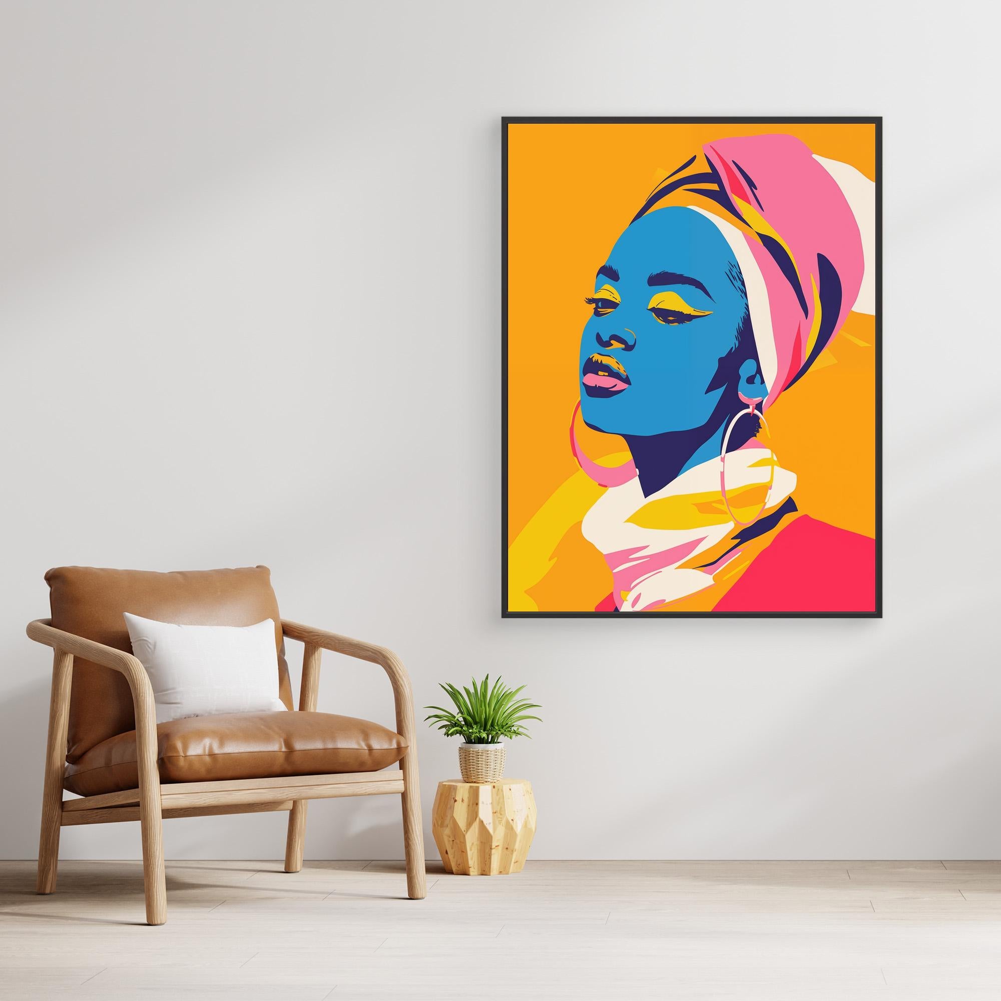 Un salon moderne présente "Got the blues for you" de Printumo, un portrait pop art coloré d'une femme avec un bandeau, prêt à être accroché au-dessus d'un fauteuil en cuir fauve, d'une petite plante et d'une table en bois sur un fond blanc.